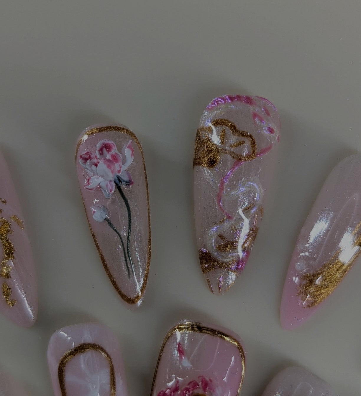 imperial dragon design in rose quartz variant. marbled pink and white veins, hand painted dragon elements, 3d lotus flowers, and gold chrome paired with pearls complete this timeless look