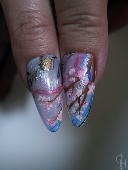 lunar new year love and deepspace set inspired by the key art for the event. pearl textured bases with semi-transparent jelly shades ranging from blue to pink to green and milky white. handpainted landscapes seen through chinese architectural-inspired frames, and apple blossoms on the thumbs. 